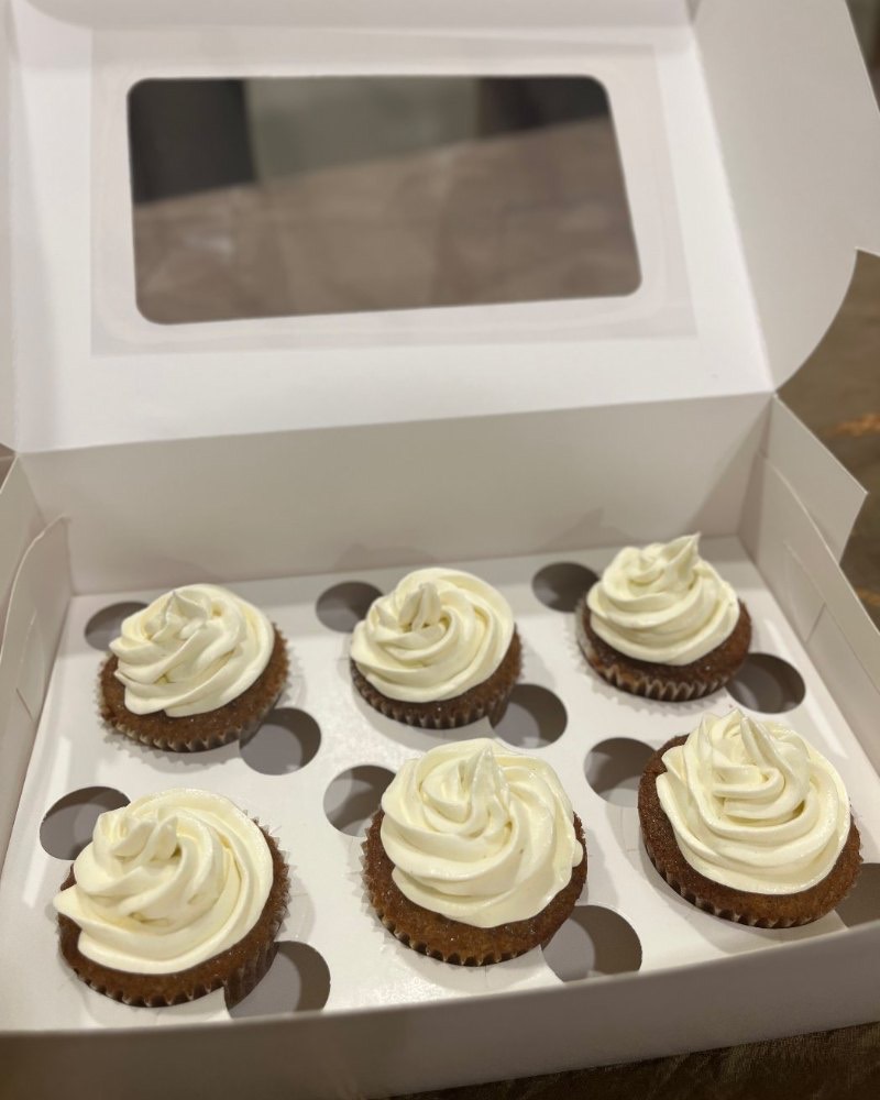 A boxed half dozen of carrot cake cupcakes